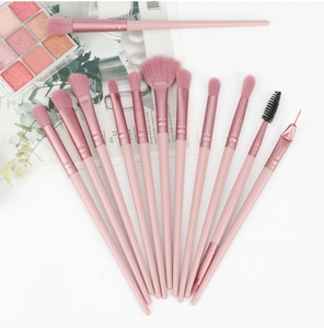 Detailed arrangement of pink professional eye makeup brushes on a decorative background