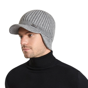 Grey winter knitted baseball cap with ear flaps and metal jeans logo decoration