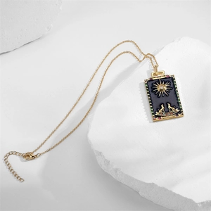 Detail of gold tarot The Moon pendant necklace with blue enamel and colorful gemstones