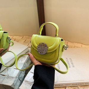 Close-up of avocado green PU leather mini crossbody bag with textured silver metal buckle