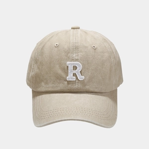 Detailed close-up of white 3D embroidered R letter on vintage washed cotton baseball cap