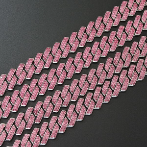 Close-up of hip-hop cuban link chains featuring pink rhinestones and silver metal finish