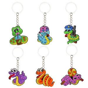 Set of six colorful PVC cartoon snake keychains with metal rings on white background