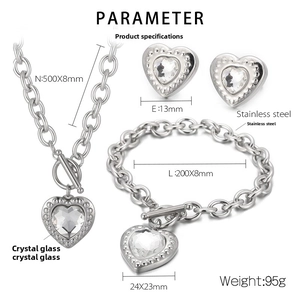Detailed view of silver heart jewelry set with OT clasp, necklace, bracelet and earrings