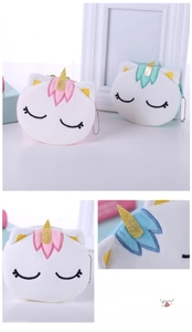 Detail of plush unicorn coin purse featuring embroidery, golden horn and metal chain