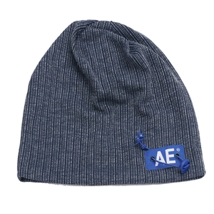 Close-up of blue striped knitted beanie featuring a square AE logo patch and drawstring