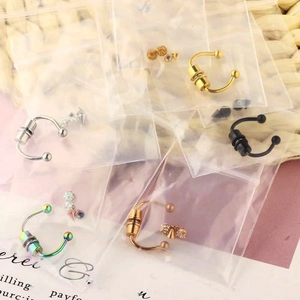 Multiple magnetic stainless steel horseshoe nose rings in various colors with packaging