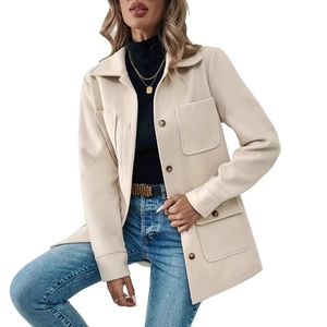 Detail of off-white oversized shacket with large flap pockets and brown buttons