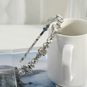Detail of luxury thin silver headband with multi-shape clear rhinestones and crystals