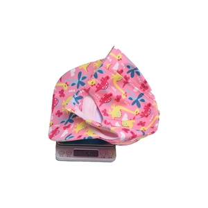 Detailed view of kids cartoon dinosaur sun hat weighing approximately 50 grams on a scale