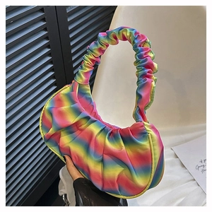 Detail of ruched rainbow gradient shoulder bag with stylish wavy handle design