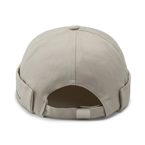 Beige cotton miki hat with small embroidery and adjustable metal buckle on white background