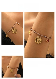 Detailed view of bohemian braided bracelets with gold flower, star and moon charms