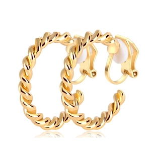 Detail of golden spiral ear clips with a minimalist hollow geometric design for non-pierced ears