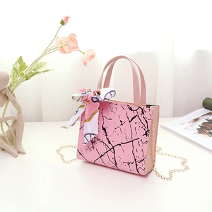 Detail of pink marble pattern handbag with golden chain strap and floral silk scarf