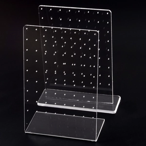 Clear acrylic jewelry display stands for stud earrings on a sleek black background