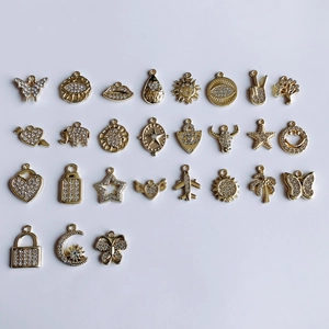 Collection of gold-plated alloy charms featuring butterfly, star, and evil eye with rhinestones