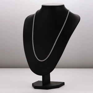 Minimalist silver woven chain necklace in stainless steel on a professional neck display