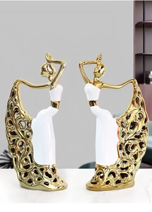 Detailed view of elegant ceramic ballerina statues with golden filigree hollow skirts