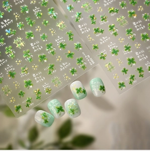 Detailed macro view of green four-leaf clover nail stickers and artistic application
