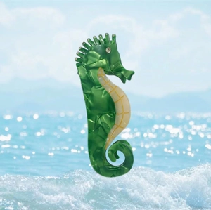 Unique seahorse hair claw clip in green marble acetate finish with sparkling rhinestone eye
