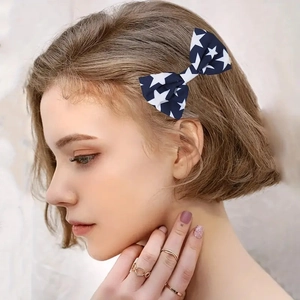 Close-up of Independence Day hair clip with blue bow and white star pattern for women