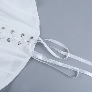 Detailed macro shot of white corset with silver eyelets and satin ribbon lacing