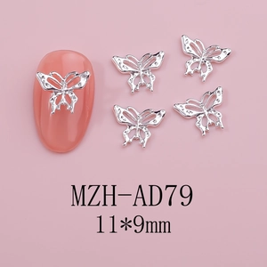 Macro detail of 11x9mm silver hollow butterfly nail charms with metal texture