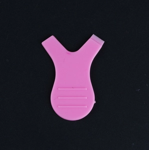 Pink Y-shaped eyelash lift tool with comb teeth and flat non-slip handle on black background
