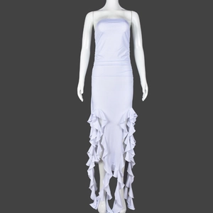Detail of white tube maxi dress showing layered ruffle hem and tiered fishtail design