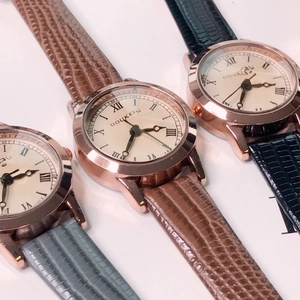 Three quartz watches with Roman numeral dials and crocodile-patterned leather straps in three colors