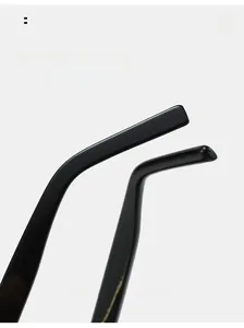 Close-up of curved glossy black temple tips on trendy cat eye sunglasses for comfort