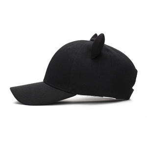 Detail view of cotton baseball cap with cute cat ear decorations and stiff brim