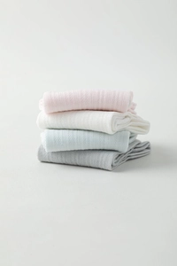 Detailed view of vertically stacked thin mesh socks in pastel macaron cotton knit colors