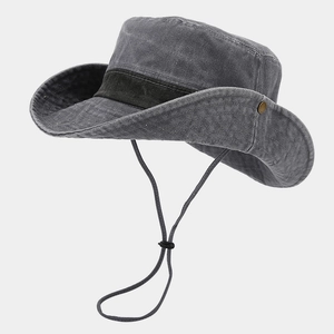 Close-up of washed cotton bucket hat with adjustable chin strap and side metal snaps