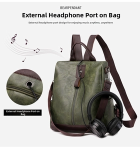 Detail of dark green PU leather backpack with an external headphone port for music on the go