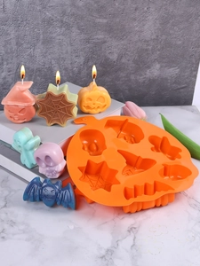 Macro detail of pumpkin shaped silicone mold with assorted Halloween candle shapes