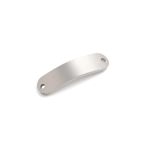 Close-up of curved stainless steel connector with brushed finish and dual hanging holes