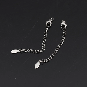 Close-up of silver stainless steel extender chains with lobster clasps and S.Steel tags