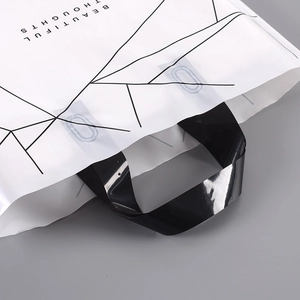 Detail of white PE plastic bag with black geometric lines and reinforced black handle