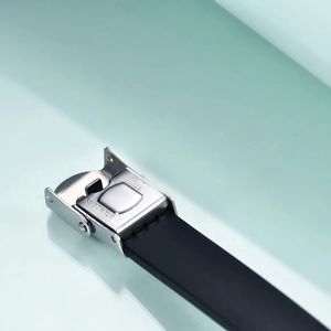 Close-up of a silver stainless steel folding clasp on a black silicone wristband