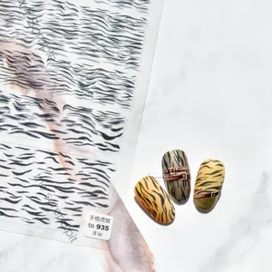 Detailed view of TO 935 ultra-thin nail stickers with hand-painted black tiger patterns