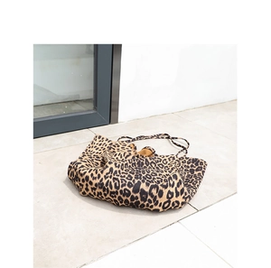 Close-up of leopard print canvas tote bag with soft fabric texture and casual style
