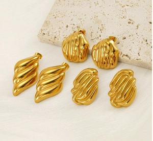 Detailed view of three pairs of 18K gold stainless steel earrings with wavy textures