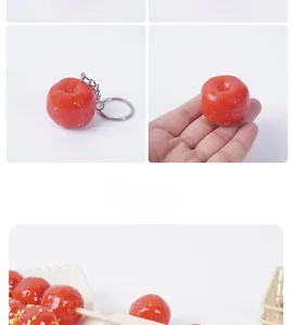 Macro view of realistic red PVC hawthorn berry keychain with metal ring and glossy finish