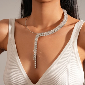 Close-up of sparkling silver rhinestone tassel necklace worn by a female model