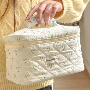 Quilted cherry print makeup bag with rainbow embroidered handle for travel storage