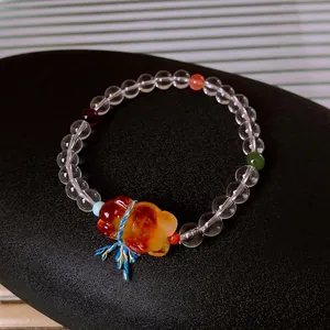 Elegant multi-gemstone beaded bracelet featuring white crystal, amber bear, and colorful beads