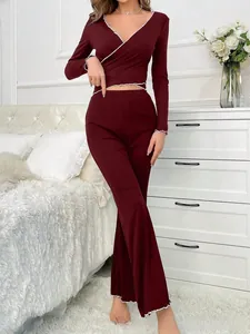 Detail of burgundy ribbed knit loungewear set with white contrast wavy scalloped edges