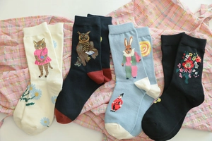 Detailed view of assorted cotton socks with embroidered cat and owl animal patterns